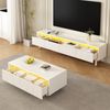 Dieser moderne LED-Couchtisch verfügt über eine gewellte Schubladenplatte, gold-weiße Beine, zwei Schubladen und einen farbwechselnden LED-Lichtstreifen. Ein passender TV-Schrank ist ebenfalls erhältl Bild 2