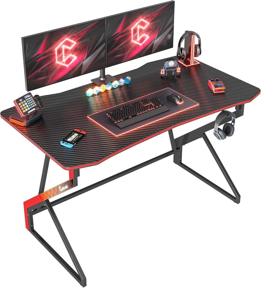 CubiCubi Gaming Schreibtisch, 120 x 60 cm Esport Ergonomischer Computertisch Tisch mit Kohlefaseroberfläche, stabiles Z-Gestell, Kopfhörerhaken zum Spielen, Lernen, Zuhause, Schlafzimmer, Schwarz Bild 1